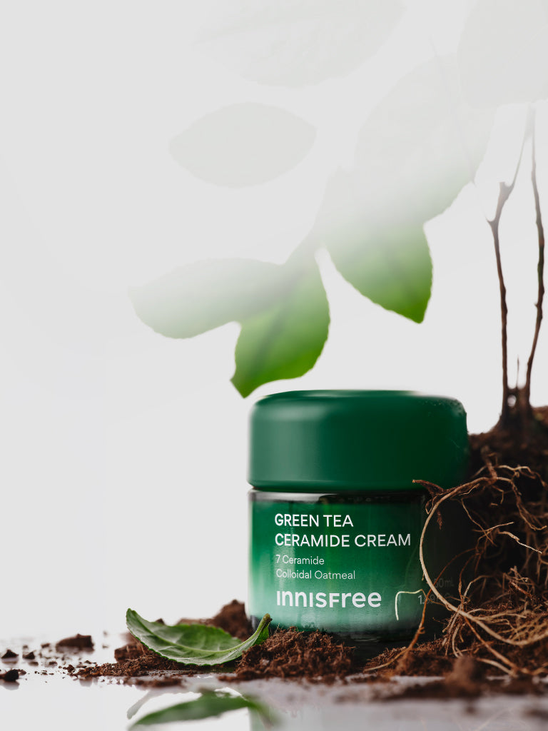 Green Tea Ceramide Cream with plant and soil background