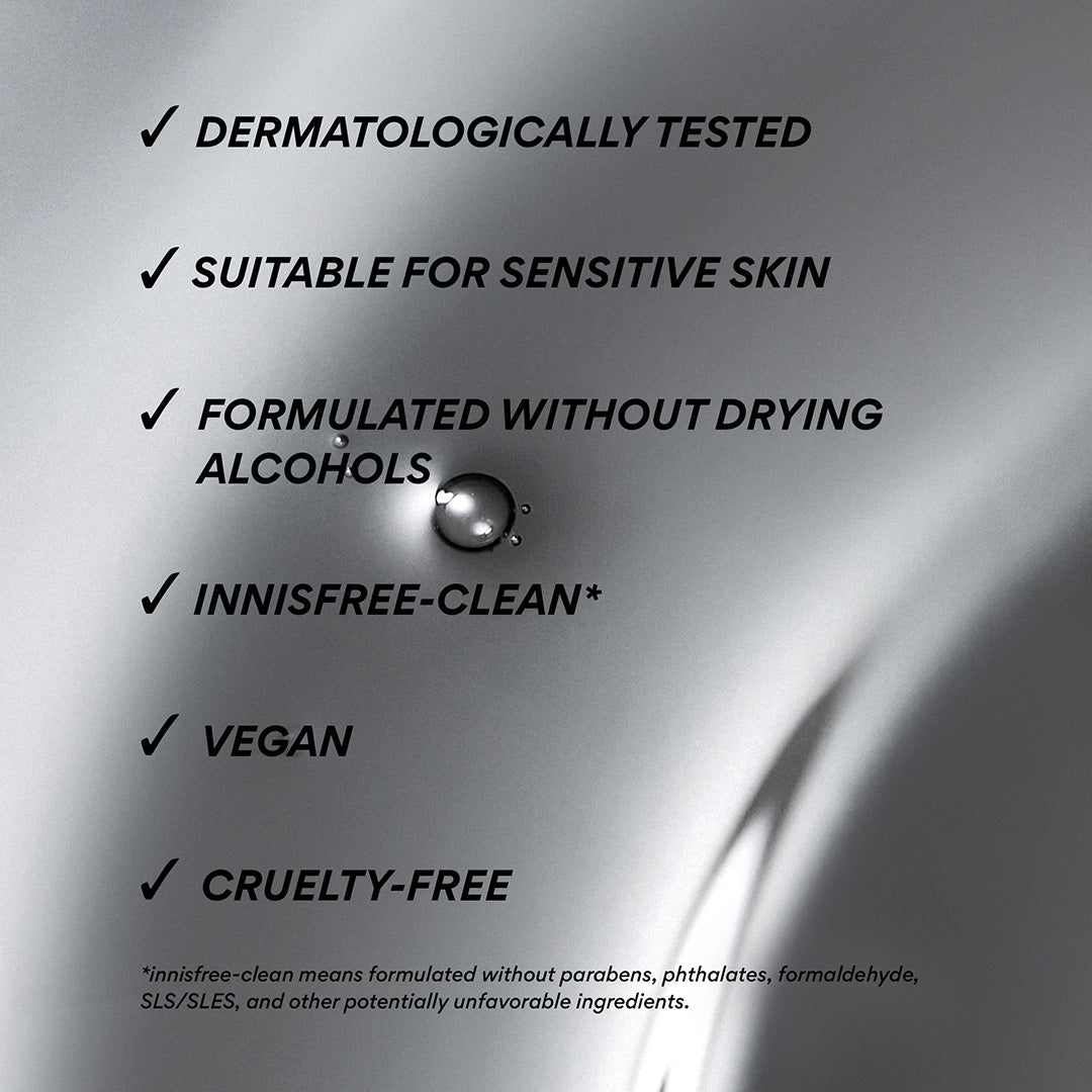 A close-up of a metallic silver surface with black text listing product benefits: dermatologically tested, suitable for sensitive skin, formulated without drying alcohols, innisfree-clean*, vegan, and cruelty-free. A small droplet sits near the center.