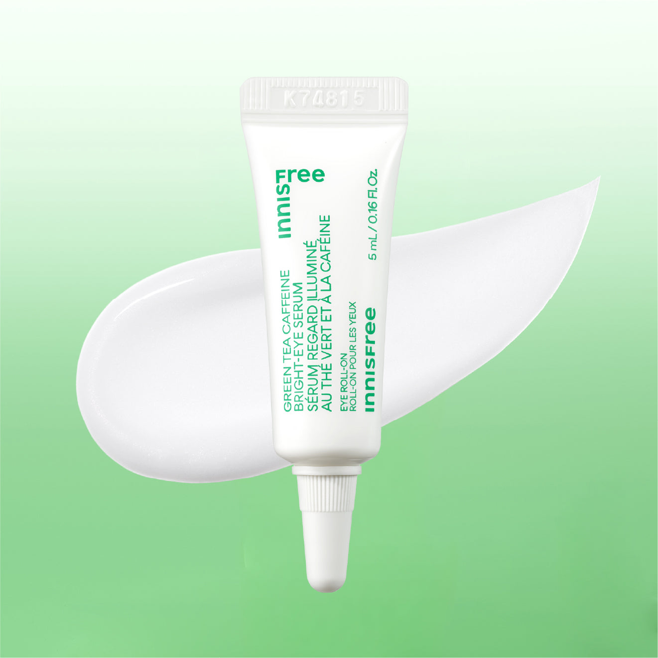 Mini Innisfree Green Tea Eye Serum in a white squeeze tube with green text, displayed against a light green gradient background with a white cream smear behind it.
