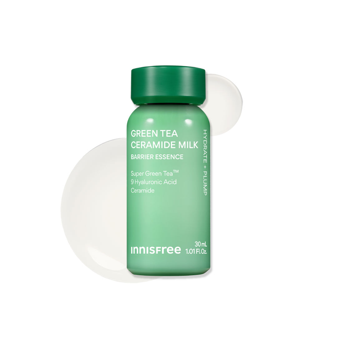 Innisfree Green Tea Ceramide Milk Barrier Essence in a 30 mL green bottle with a dark green cap, shown on a white background with a translucent green and white circular smear behind it.