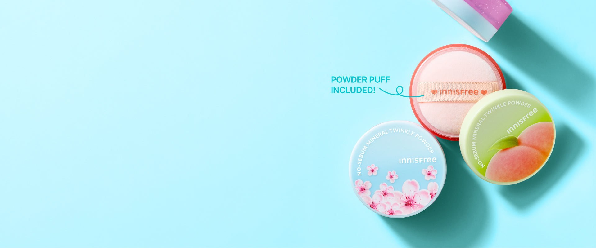 Three innisfree No-Sebum Mineral Twinkle Powders arranged on a light blue background, with one open pink puff labeled 'POWDER PUFF INCLUDED!' and two closed puffs featuring printed floral and peach illustrations. The brand name 'innisfree' is visible on the lids.