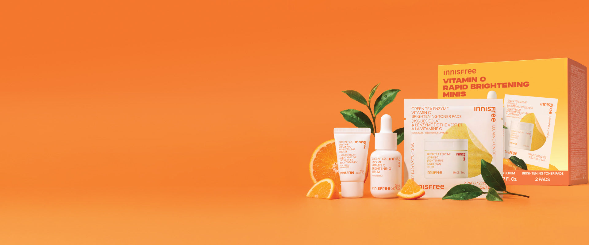 innisfree Vitamin C Rapid Brightening Minis Set styled with orange slices, green leaves, and an orange background.