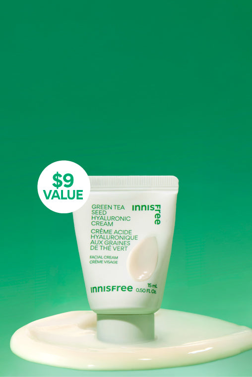 Innisfree Green Tea Seed Hyaluronic Cream 15mL stands on a glossy white cream pool against a bright green gradient background. A white circular badge on the left reads '$9 VALUE'.