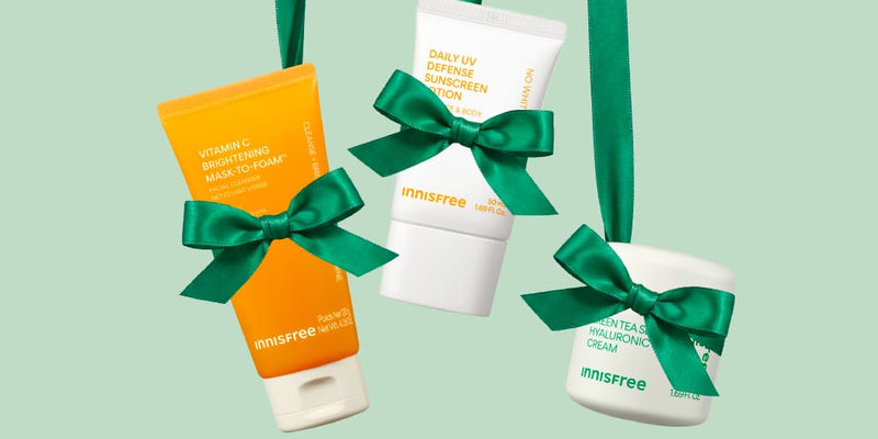 Vitamin C Brightening Mask-To-Foam™ Facial Cleanser, Daily UV Defense Sunscreen Lotion, and Green Tea Seed Hyaluronic Cream in green bows