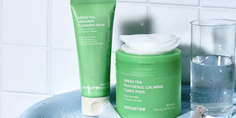 Green Tea Cleansing Balm and Green Tea Calming Toner Pads in a bathroom setting