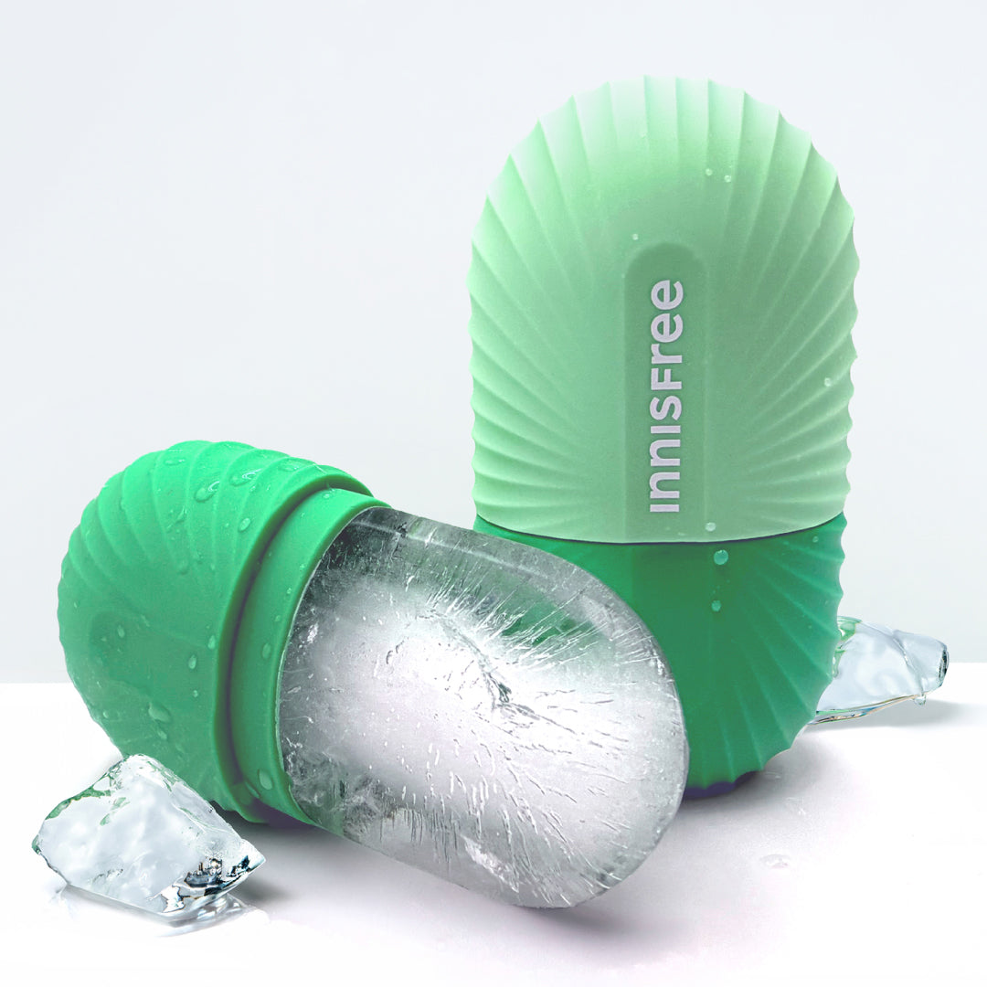 A mint green Innisfree silicone ice mold shown with one mold upright containing a frozen ice cube and another lying on its side, photographed on a clean white background.