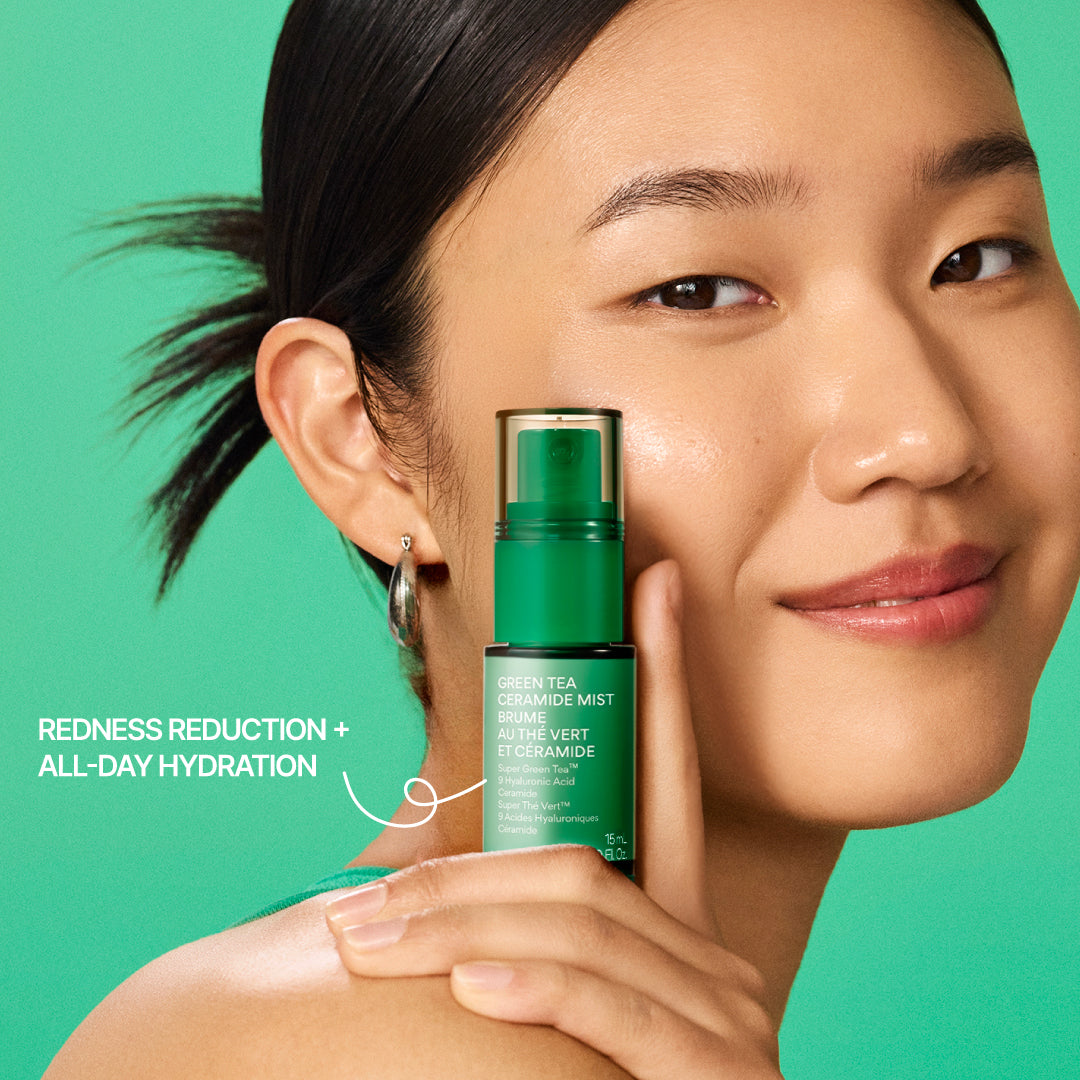 A woman with dark hair pulled back holds a green bottle of innisfree Green Tea Ceramide Mist 15mL against a solid green background. White text on the left reads 'REDNESS REDUCTION + ALL-DAY HYDRATION'.