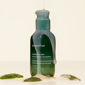 Green Tea Hyaluronic Acid Serum with Texture spilling over the bottle